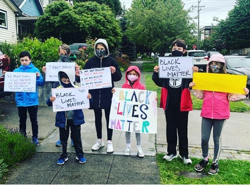 Kelli McDole takes pictures of families gathering for a peaceful protest in Greenwood.