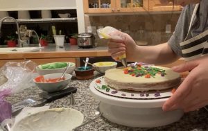 Lucy decorating the embroidery cake