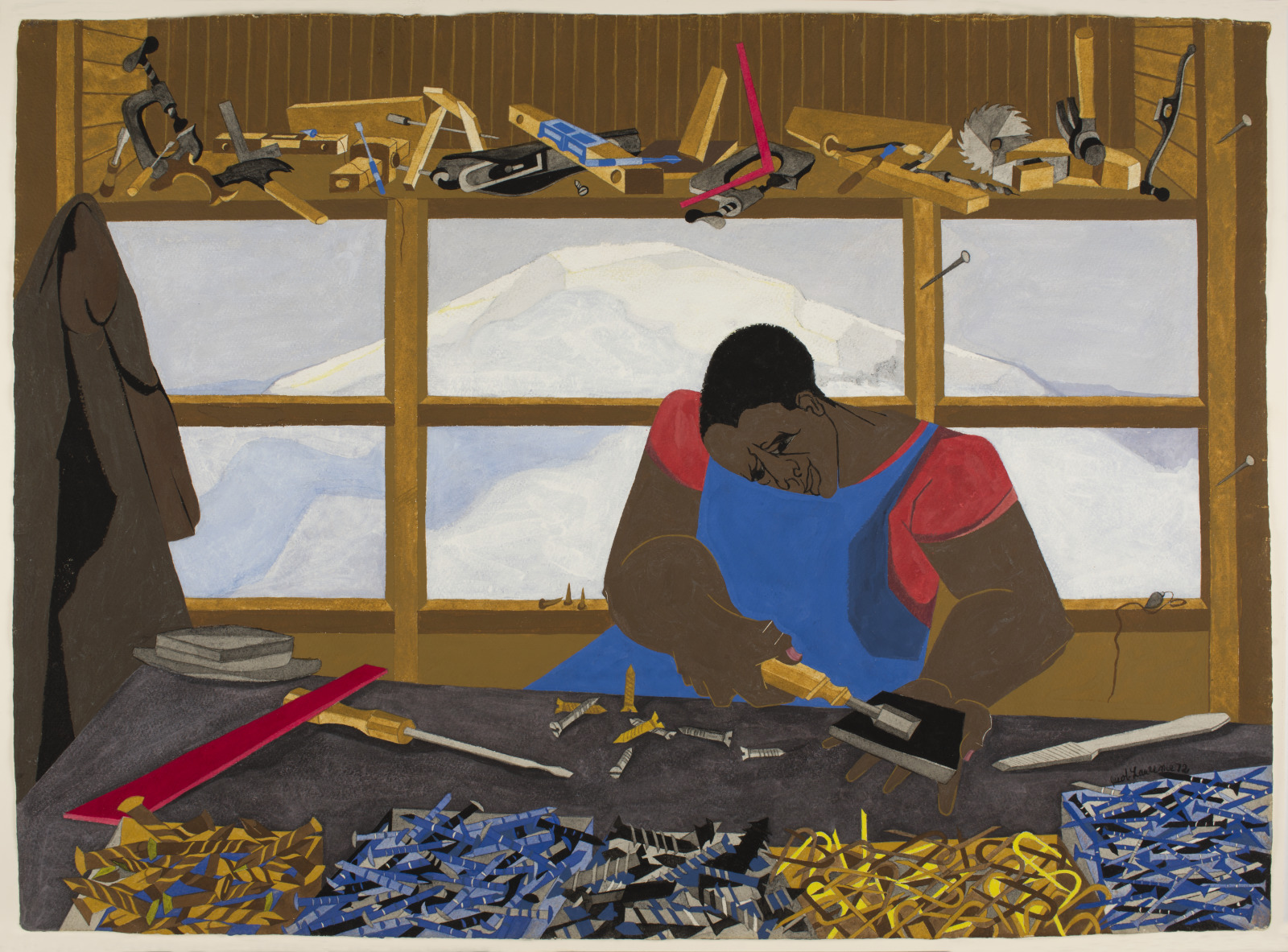 An African American man seated at a work bench, sharpening his carpentry tools, a view of mt. Ranier is present in the windor behind him and he is surround by an array of tools.