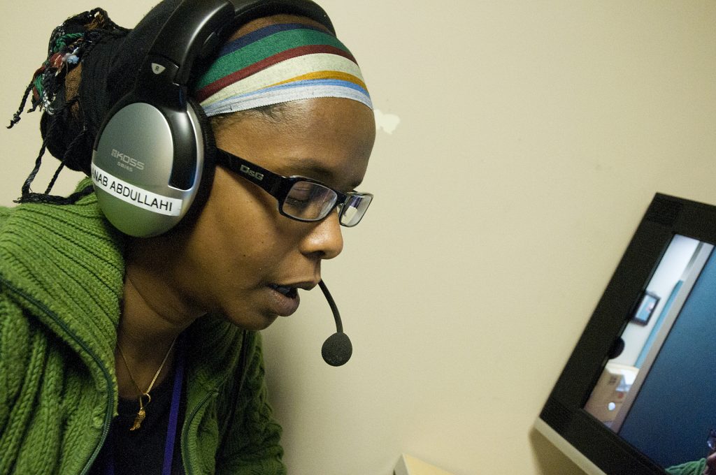 A translator's services being used via verbal communication, using a headset.