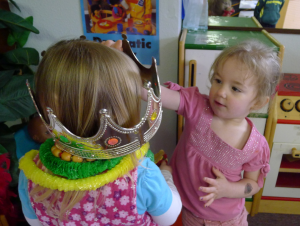 preschoolers playing with a plastic crown