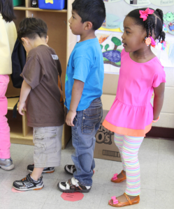 Preschoolers waiting in a single-file line