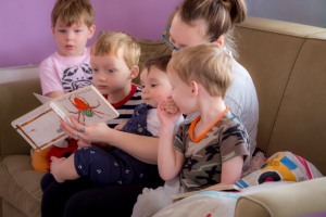 Caregiver reading to children