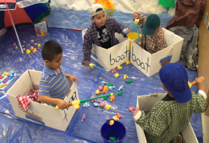 Children playing in pretend boats