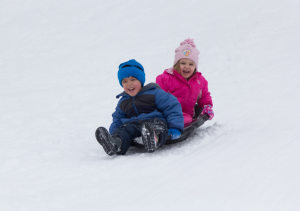 Children on toboggan in the snow