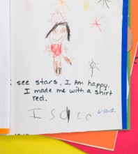 child's drawing that the educator labeled with, "See stars. I am happy. I made me with a shirt red." The child wrote his name.