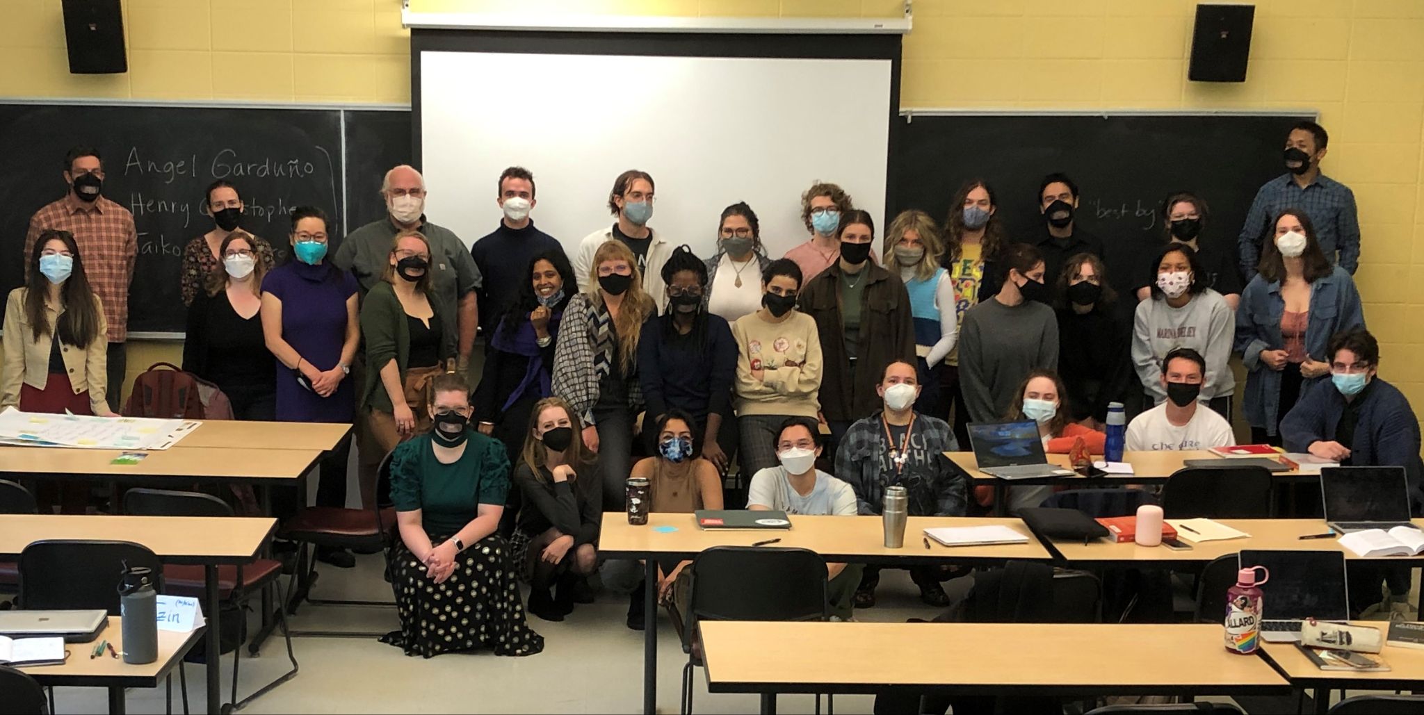 Image description: The 2022 English 131 Orientation Cohort poses for a photo in the Mechanical Engineering Building. Everyone is masked and many are smizing.
