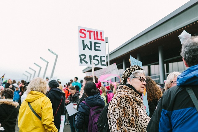 A picture of people walking with signs in a protest.