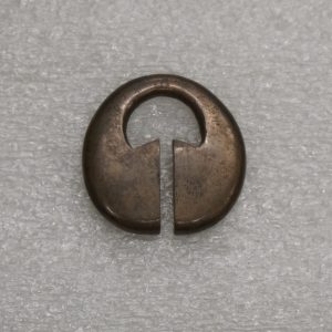 A tarnished lingling-o pendant without a string