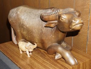 2 wooden Carabao statues