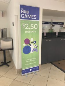 A poster advertisement in the HUB dining area conveying $2.50 Tuesday at the HUB games to students eating there. | Photo Credit: Kelly Giang License CC BY NC SA