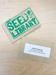 Two brown seed packets. One is stamped with the UWT seed library logo in green ink. The other has planting information for western buttercup.