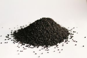 A pile of small, black seeds against a white background.